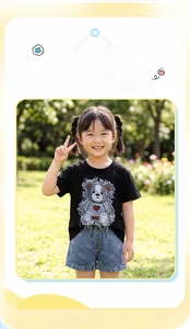 Detail of girls' summer set with black cartoon bear T-shirt and blue denim shorts