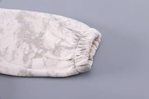 Detail of ribbed knit cuffs with grey tie-dye pattern on long sleeve kids top