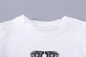Detailed close-up of white cotton t-shirt collar with double-needle stitching and black print