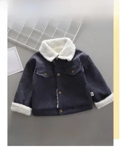 Detail of dark blue corduroy jacket for boys with white faux fleece collar and cuffs