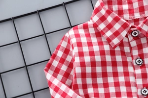 Dettaglio della trama del tessuto della camicia a quadri bianchi e rossi per bambini
