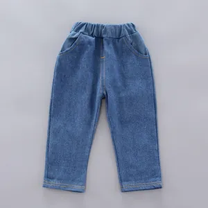Close-up of boys deep blue denim pants featuring elastic waist and orange contrast stitching