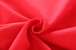 Close-up of soft red knitted cotton fabric texture with detailed ribbed stitching