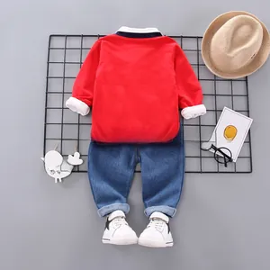 Flat lay of boys three-piece casual set featuring color-block sweatshirt and denim pants