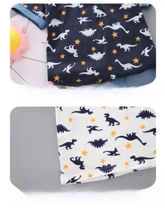 Detail of premium cotton knit stitching and dinosaur print on polo shirt set