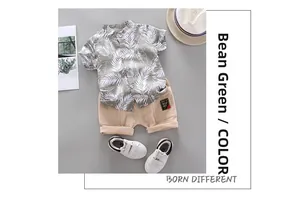 Detail of boys' palm leaf print shirt in bean green with cargo shorts and fabric patch