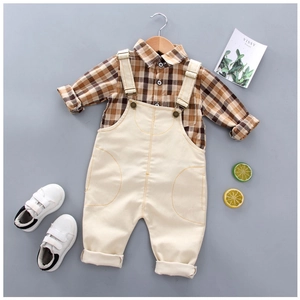 Kids plaid shirt and beige overalls set for spring, presented on a flat lay background