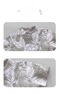 Detail of boys' short sleeve shirt featuring tropical palm leaf print and stand collar finish