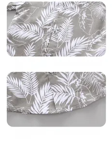 Detail of tropical leaf print shirt with branded buttons and neat hem stitching