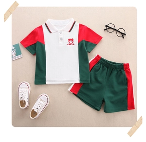 Detail of kids polo set showing the bear embroidery and color-block cotton fabric