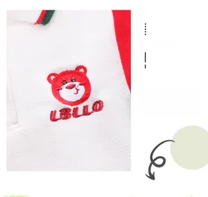Detail of baby polo shirt with red bear embroidery and bicolor striped collar