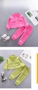 Detail view of girls casual autumn tracksuit sets in vibrant pink and green colors