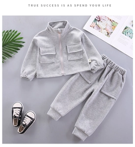 Flat lay detail of grey cotton sports set featuring cargo pockets and ribbed cuffs