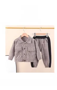 Close-up of kids light brown textured jacket set with cargo pockets and side stripe pants