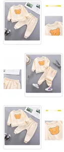 Detail of boys' beige cotton sweatshirt with cartoon bear print and elastic waistband