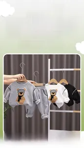 Detail view of ribbed cuffs and three-dimensional cartoon bear on children's tracksuit