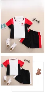 Detail view of children's polo set with red bear logo and contrast color athletic design