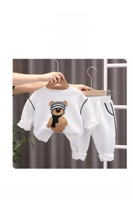 Detail of white waffle texture fabric and brown bear applique on children sweatshirt set