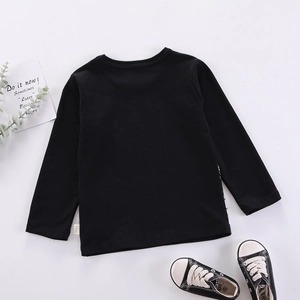 T-shirt noir à manches longues pour garçon en coton doux présenté avec des baskets