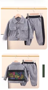 Detail view of children's grey plaid jacket set featuring back colorful letter print