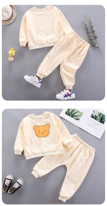Detail of baby boys cream bear sweatshirt and joggers set with ribbed cuffs and hem