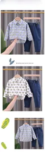 Detail of boys' casual outfit featuring letter print long sleeve shirt and denim trousers