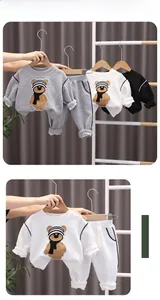 Close-up of kids waffle knit tracksuit with cartoon bear patch and ribbed cuffs