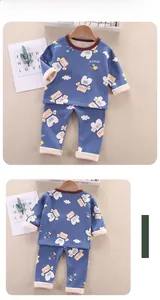 Flat lay of warm thermal kids pajamas with astronaut bear print and soft fleece lining