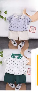 Flat lay of boys' palm tree print polo shirts and shorts summer sets for toddlers