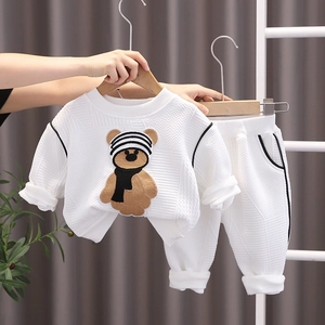 Kids white waffle knit tracksuit featuring a cartoon bear patch sweatshirt and pants