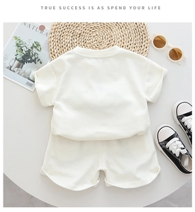 Flat lay of boys summer outfit set featuring short sleeve t-shirt and matching shorts