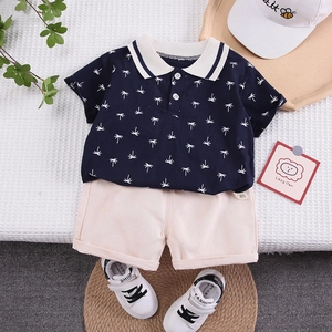 Toddler boys two-piece summer set with navy palm tree polo shirt and beige shorts