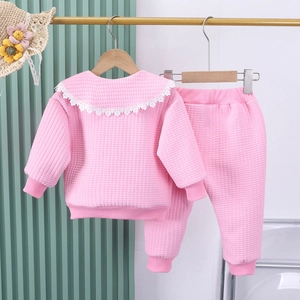 Detail of pink waffle knit girl outfit with elegant white lace collar and ribbed cuffs