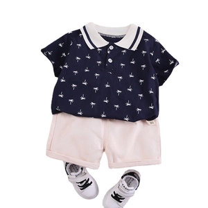 Boys navy polo shirt with coconut tree print, beige shorts and white sneakers set