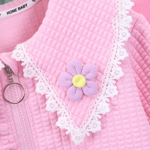 Close-up of pink waffle texture jacket with lace collar and purple flower detail
