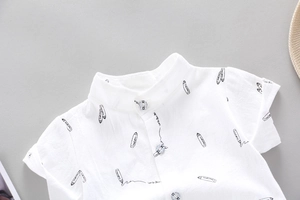 Detail of white cotton toddler shirt with black pencil print and polo collar design