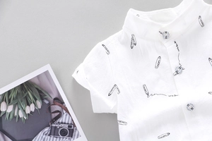 Detailed view of textured white cotton shirt with black pencil sketches and mandarin collar