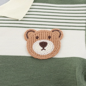 Detailed view of striped knit polo shirt for baby boys featuring a brown crochet bear patch
