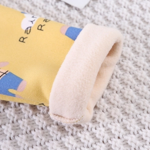 Close-up of thick fleece lining and cartoon print on yellow thermal kid's sleepwear