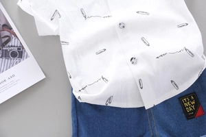 Detail of white printed shirt and denim shorts with 'IT'S A NEW DAY' patch