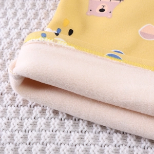Detailed close-up of thick fleece lining and cartoon bear print on kids' warm thermal suit
