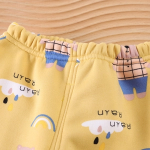 Close-up of children's yellow thermal pants with bear prints and elastic waistband detail