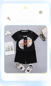 Detail of boys summer Hanfu set with black t-shirt featuring a dragon print and Chinese text