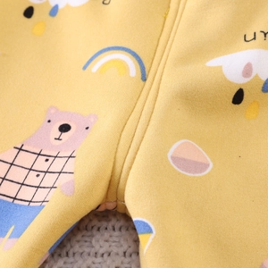 Close-up of yellow cotton kids thermal wear featuring cartoon bear and rainbow prints