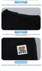 Detail of toddler black pants featuring elastic waistband and 3D bear fabric label