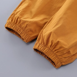 Detailed close-up of elastic ribbed cuffs on mustard yellow toddler jogger pants