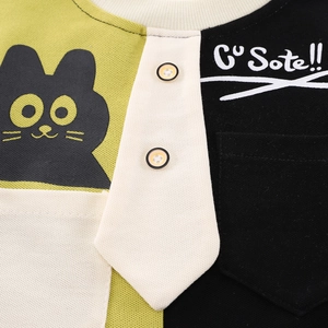 Detail of boys' patchwork t-shirt with cartoon cat print and decorative buttons