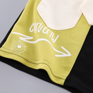 Detailed macro of breathable piqué fabric with monster print on boys' two-piece set