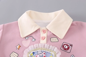 Detail of pink girls' polo sweatshirt featuring lace trim and cute cartoon bear embroidery