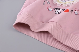 Detail of pink girls hoodie featuring lace collar and ribbed hem with cute cartoon prints